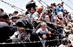 Syrian refugees at Turkey-Syria border...epa04791762 A picture t